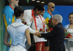 Enhamed Enhamed recibe la medalla de oro de los 100 metros mariposa de manos de Juan Antonio Samarach.